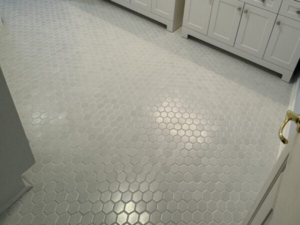 Hexagon mosaic tile bathroom floor with even grout lines