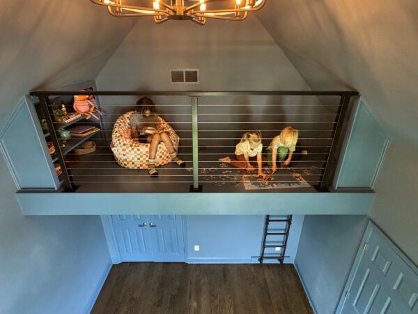 Kids play loft with cable railing and ladder above a closet