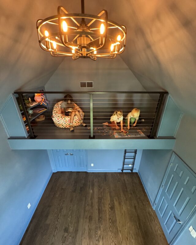 Play loft with cable railing and ladder built into vaulted space above a closet