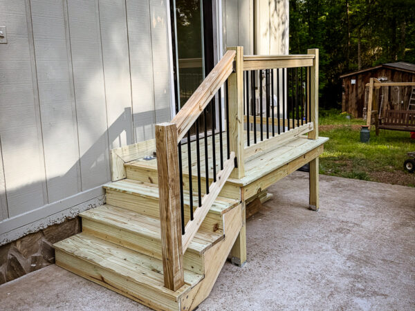 Small pressure-treated deck and stairs with black railings