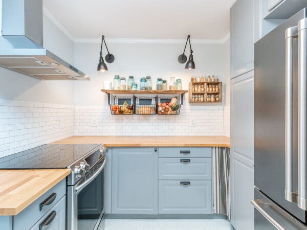 White subway tile backsplash with open shelving in a small kitchen